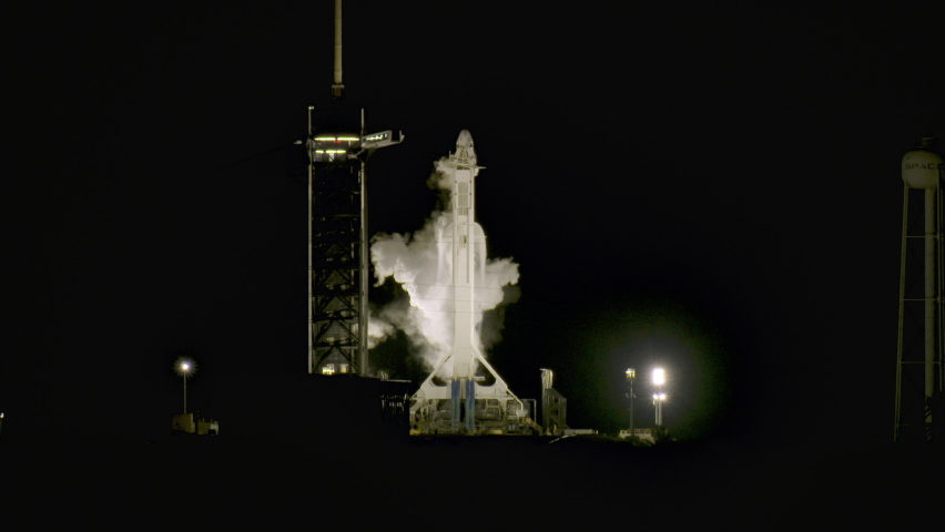 SpaceX Rocket for NASA Crew Dragon sits on launch pad 39A as it vents fuel and gases for launch at Kennedy Space Center for first Mission CREW-1 to the International Space Station at night. Royalty-Free Stock Footage #1073462258