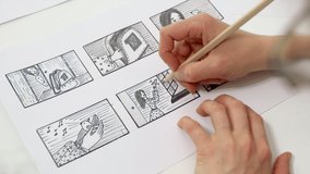 Artist animator draws cartoon storyboard sketches. Comics concept. 4K.