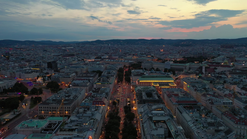 Sunset sky night illuminated vienna city center opera house traffic street aerial panorama 4k austria