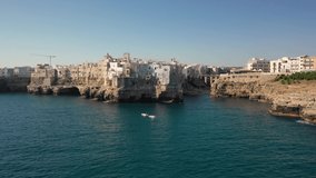 Polignano a Mare,Puglia,Bari,Italy.Beautiful 4K panoramic aerial video from flying drone to beach Lama Monachile,Polignano a Mare new and old city, Adriatic sea and Turquoise sea water. (Series)