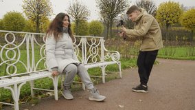 Mother with son walk in autumn park boy with mobile phone camera recording outdoor video blog. Teenager shooting video for travel vlogging. Catherine Park, Tsarskoye Selo, Saint Petersburg, Russia.
