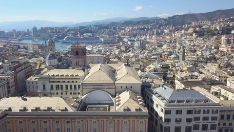GENOA, ITALY - SEPTEMBER, 2020. Aerial panoramic drone view of buildings and streets surrounding Port of Genoa.Cruise ships and ferries in port. Old famous city with houses, roofs, buildings. 4K video