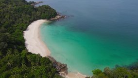Phuket, Thailand. Professional Video. Aerial view shot. Drone camera over white beach sand and sew water clear. Nature video view of beautiful tropical beach and yacht at sea.