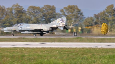 Andravida Greece APRIL, 03, 2019 Military plane with two jet engines brakes after landing by opening the tail parachute. McDonnell Douglas F-4E Phantom II of Hellenic Air Force