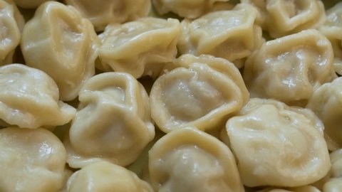 Cooked Delicious Vegan Dumplings, Close-up, Isolated, Rotation. Background of Vegetarian Delicious Dumplings. The Concept of Healthy Vegetarian Food and Vegan Diet.