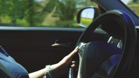 Video, woman hands drive a automobile, beautiful fingers lie on the steering wheel.