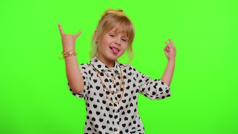 Rock-n-roll gesture. Overjoyed delighted funny stylish blonde kid child showing cool sign by hands shouting yeah with crazy expression, dancing emotionally rejoicing in success. Teenager children girl