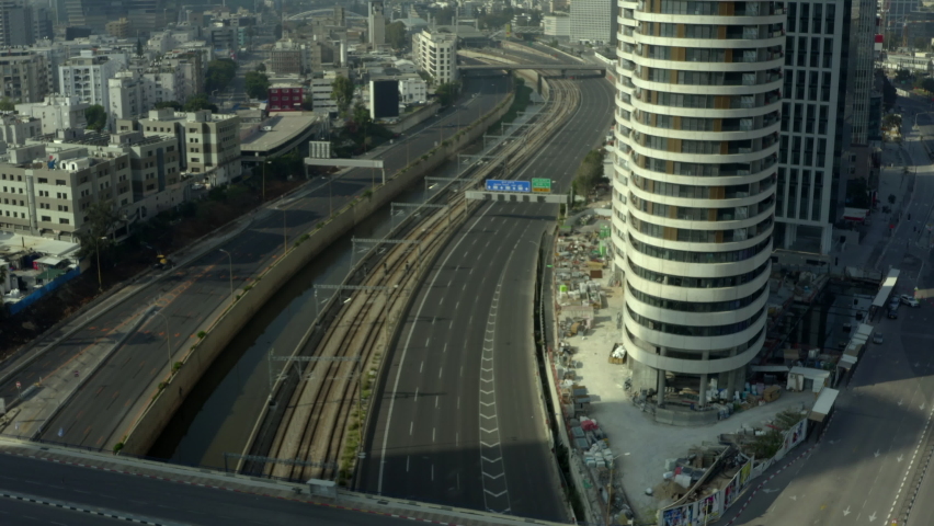 Aerial Shot Of Highways By Modern Building On Sunny Day, Drone Flying Over Roads During Lockdown - Tel Aviv, Israel