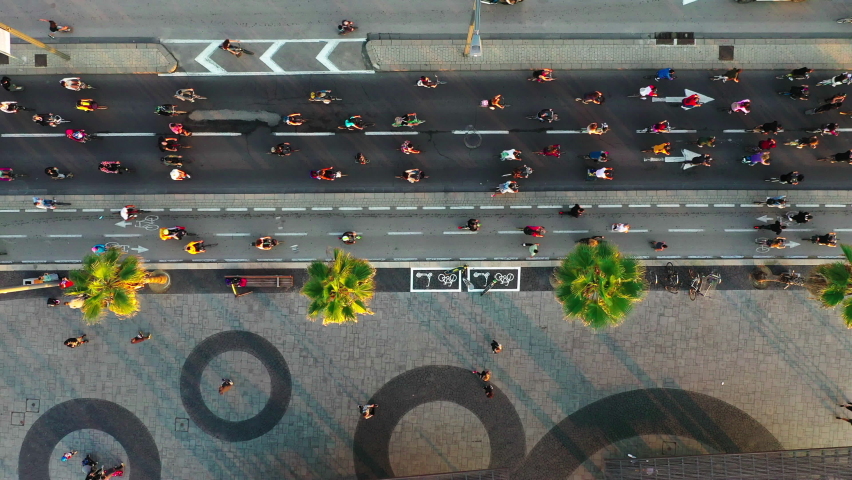 Aerial Lockdown Shot Of People Riding Bicycle During Rally In City, Drone Flying Over Road - Tel Aviv, Israel | Shutterstock HD Video #1073509067
