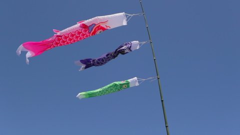 Slow Motion Shot Of Colorful Wind Socks Against Clear Sky On Sunny Day - Big Island, Hawaii