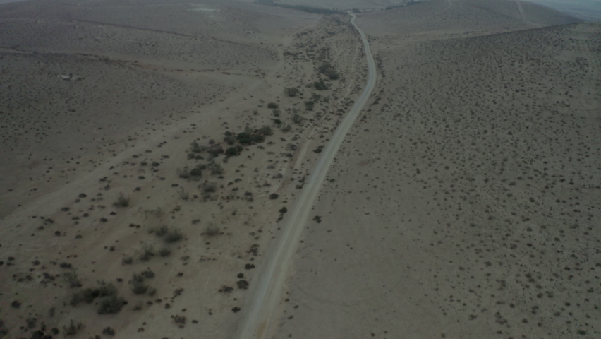 Aerial Tilt Up Shot Of Road In Desert Against Sky During Sunset, Drone Flying Forward Over Landscape - Negev, Israel