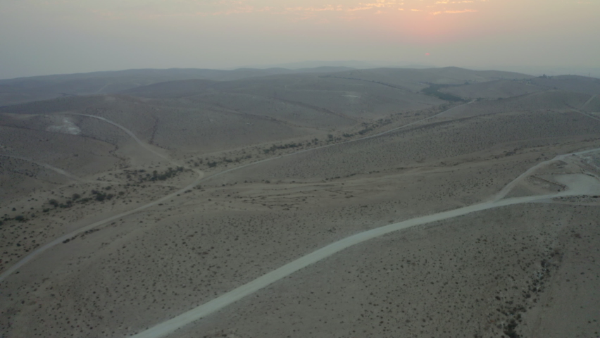 Aerial Tilt Up Shot Of Desert Against Sky During Sunset, Drone Flying Forward Over Landscape - Negev, Israel