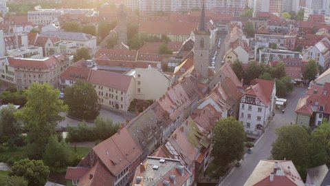 Aerial Moving Forward Over The Historic Merchant'S Bridge In The Old City, With Timber Framed Houses, Steep Roofs, Steeples, And Narrow Streets - Erfurt, Germany