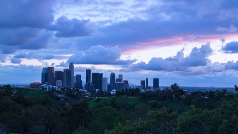 Time Lapse Shot Of Illuminated Structures Against Purple Sky, Trees In City During Sunset - Los Angeles, California