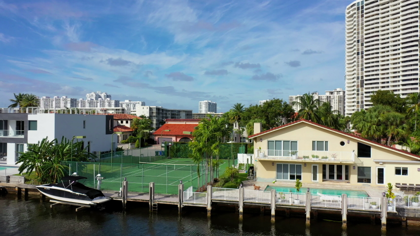 Aerial Ascending Forward Shot Of Residential Structures Amidst Sea, Drone Flying Over City On Sunny Day - Miami, Florida