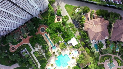 Aerial Top Forward Shot Of Houses Located By Canals In City, Drone Flying Over Structures On Sunny Day - Miami, Florida