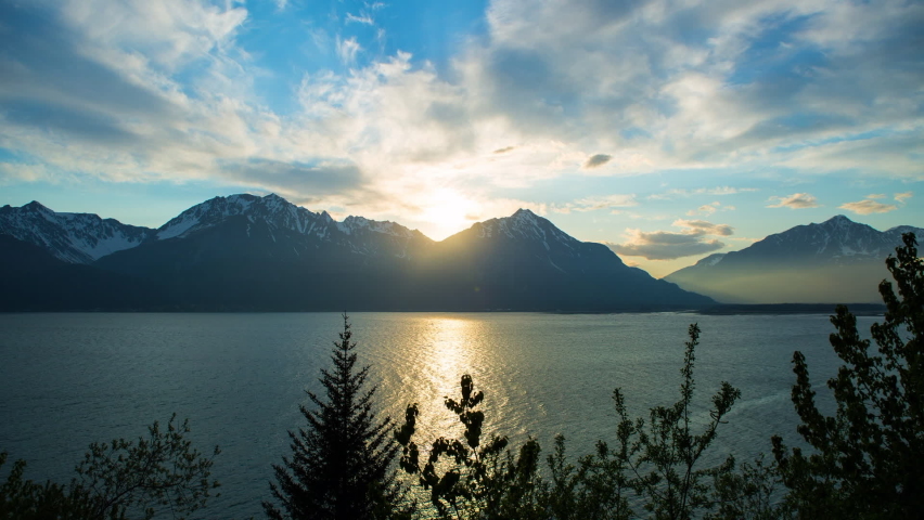 Time Lapse Lockdown Shot Of Scenic View Of Sea And Mountains During Sunset Against Cloudy Sky - Seward, Alaska