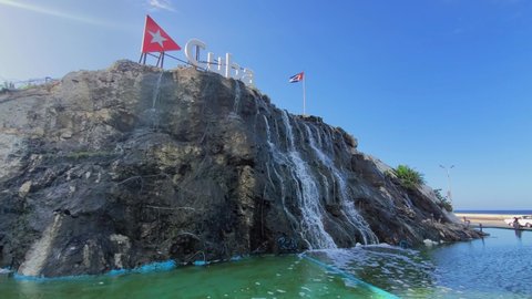 Cuba Waterfall Fountain on EL Malecon, Avenida de Maceo, a broad landmark esplanade that stretches for 8 km along the coast in Havana past major city tourist attractions.