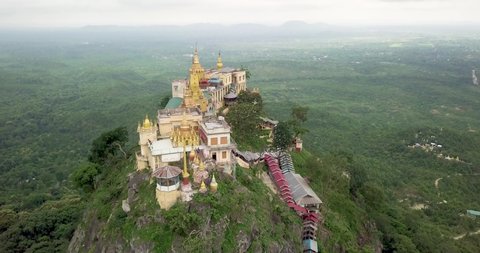 Aerial flyby shot of ancient temple on top of Mount Popa, Myanmar (Burma)