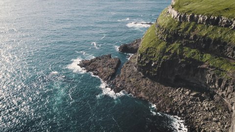 Slowmotion Drone Aerial Footage of green nature and the ocean in Faroe Islands, Denmark weather