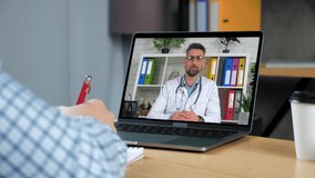 Man doctor in laptop screen communicates tells consults remote online video conference call chat computer webcam. Patient client at home writes treatment in notebook listen distance medical worker