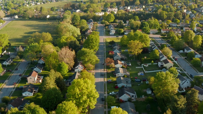 Residential suburban housing district area in USA. American homes in quiet neighborhood. Aerial truck shot at golden hour. | Shutterstock HD Video #1073546474