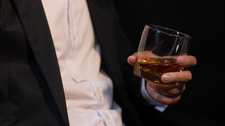 Business people sit whiskey holding whiskey, a restaurant