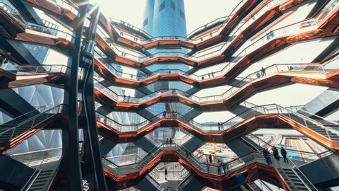 New York City, United States - Apr 3, 2019: Time-lapse of people travel at the Vessel in Hudson Yards Public Square, NYC USA. NY tourism landmark, tourist attraction, traveler lifestyle concept