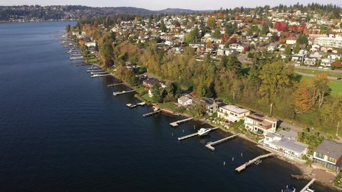 Cinematic aerial drone clip of Market, Norkirk, Kirkland, Moss Bay, Lake Washington in autumn foliage, commercial, residential neighborhood near Bellevue and Seattle, King County, Washington