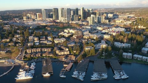 Cinematic aerial sunset drone trucking footage of Meydenbauer Bay Park, Clyde, Eastland, beach park, marinas with Lake Washington Whalers Cove waterfront mansions in Belleview near Seattle, Washington