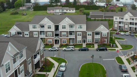Aerial of large modern apartment building complex. Residential housing in USA. Establishing pullback reveal reverse dolly shot.
