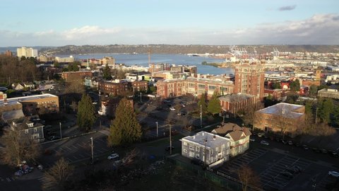 Cinematic flyover shot of downtown Tacoma, harbor, dome, Commencement Bay, Puget Sound, Tacoma, a large city near Seattle in Western Washington, Pacific Northwest, economic center of Pierce County