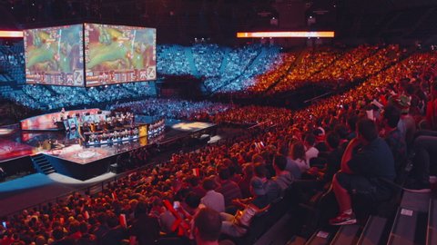 Paris, France; September 3rd, 2017: League of Legends Final tournament. Excited gamers using thundersticks to encourage their teams. Travelling shot and slow motion. 