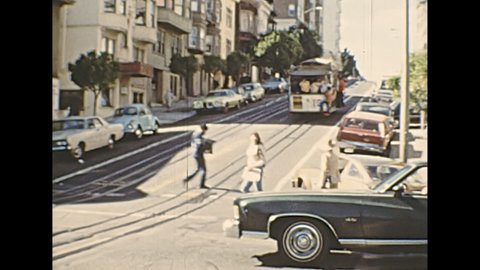 San Francisco, United States - in 1976: old vintage car and Cable Car of San Francisco, for Van Ness Avenue, California and Market streets. Restored archival video in the 1970s.