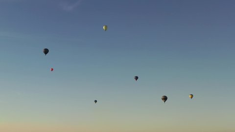 Hot air balloon in flight at sunset. View from the drone. 