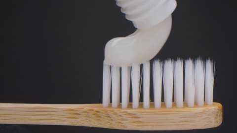 Super close up view of toothpaste with toothbrush. Beautiful slider shot of toothpaste. White teeth. Eco toothbrush.