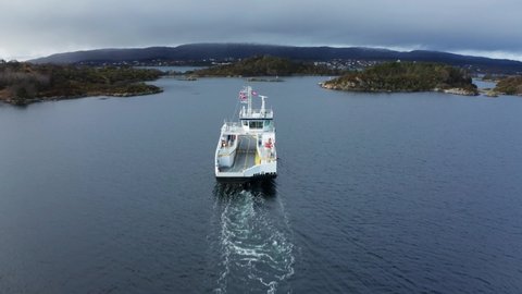 Flying over electric car ferry at sea - Birdseye aerial Norway