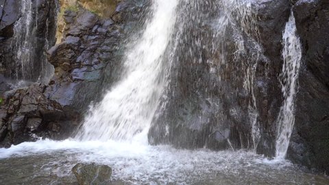 Waterfall falling from Atlas mountain on rocky surface in Morocco - static medium steady shot