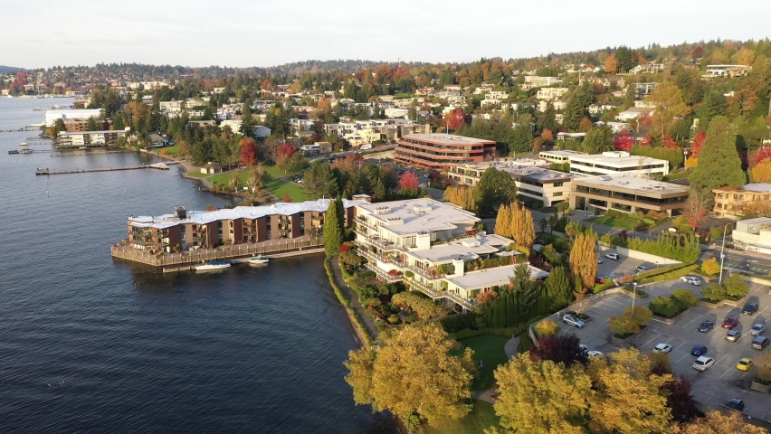 Cinematic aerial drone footage of waterfront apartments in Kirkland, Lake Washington in autumn foliage, commercial, residential neighborhood near Bellevue and Seattle, King County, Washington