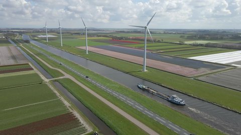 Rural infrastructure in Holland with road, water canal and wind turbine