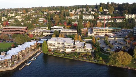 Cinematic orbiting drone footage of Kirkland, waterfront, Moss Bay, Lake Washington in autumn foliage, commercial, residential neighborhood near Bellevue and Seattle, King County, Washington