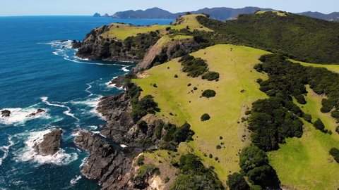 Beautiful Island Of Urupukapuka With Waves Crashing On Cliffs In New Zealand. - aerial