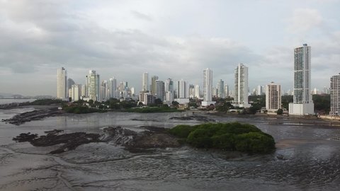 Urban skyscrapers of Panama City with Pacific mud flat in foreground