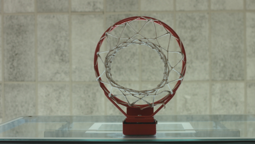 Static shot of a ball hitting the basket backboard, passing through a hoop and shaking the net, low angle view Royalty-Free Stock Footage #1073597990