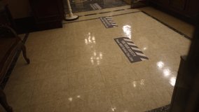 This panning video features COVID public health safety signage and markings on a floor.