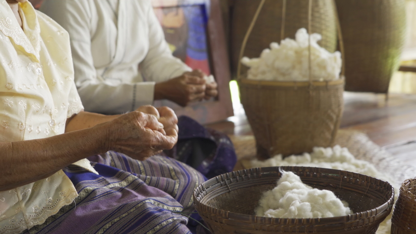 Local people hands making textile cloth fabric cotton fiber, handmade craft material fabric. Traditional people lifestyle. Embroidery.