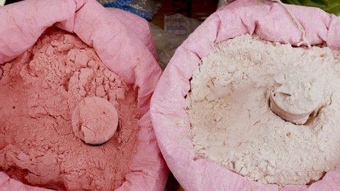Pink and white clay powder for making beauty face mask in a street market in Marrakech, Morocco. Healthy holistic skin care and beauty treatment used in hammam and at home.