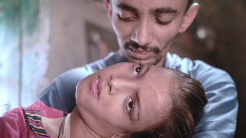Elder brother kisses her younger disabled sister in a small village house