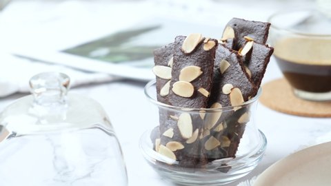 crunchy brittle brownie crisps crackers set on white cafe table.