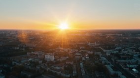 Aerial time lapse hyperlapse sunrise over big city, morning cityscape. Drone flight over industrial landscape. Bright sun beams on horizon. Belarus, Minsk at dawn overlooking city skyline - Powered by Shutterstock - Get 15% off with code: PIKWIZARD15